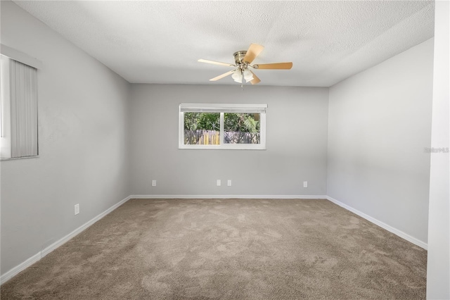 unfurnished room featuring carpet, baseboards, ceiling fan, and a textured ceiling