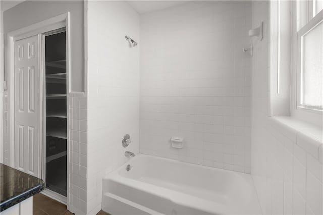 full bathroom with a spacious closet, tile patterned flooring, and bathtub / shower combination