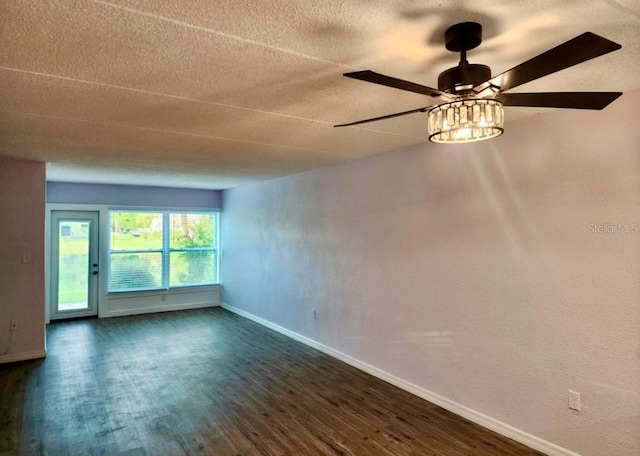 spare room with ceiling fan, dark hardwood / wood-style floors, and a textured ceiling