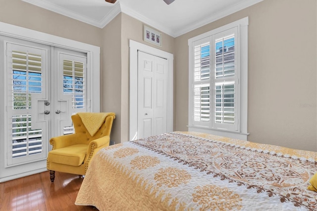 bedroom featuring french doors, multiple windows, wood finished floors, and crown molding