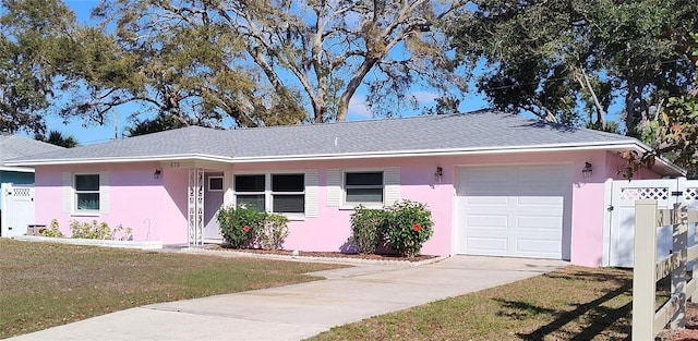 single story home featuring stucco siding, driveway, a front lawn, fence, and an attached garage