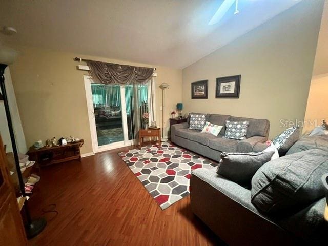 living area with vaulted ceiling and wood finished floors