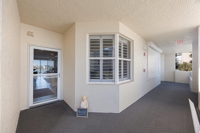 entrance to property with stucco siding