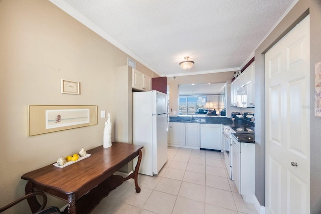 kitchen featuring ornamental molding, light tile patterned flooring, a sink, white cabinetry, and white appliances