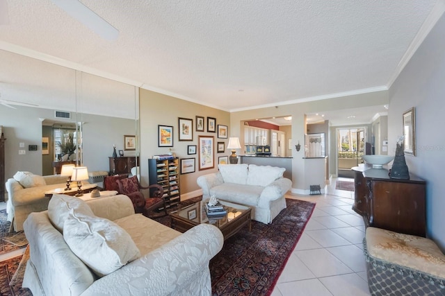 living room featuring ornamental molding, visible vents, a textured ceiling, and light tile patterned flooring