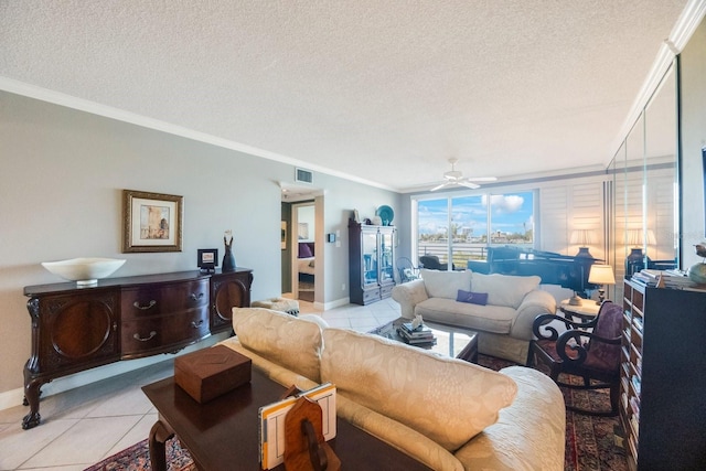 living area with visible vents, ornamental molding, light tile patterned flooring, ceiling fan, and a textured ceiling