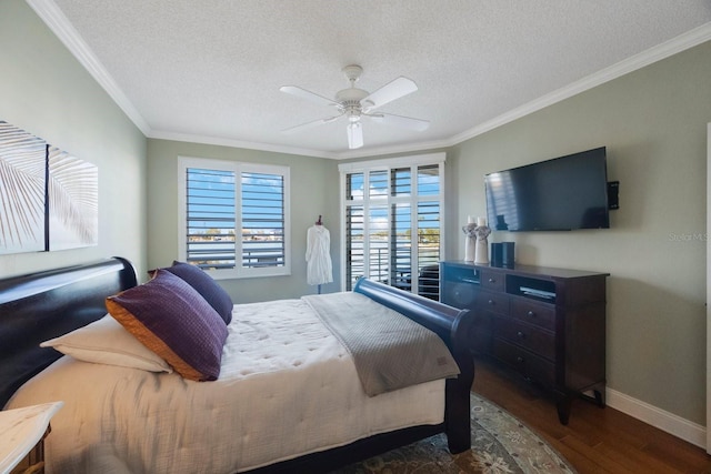 bedroom with dark wood finished floors, ornamental molding, a ceiling fan, a textured ceiling, and baseboards