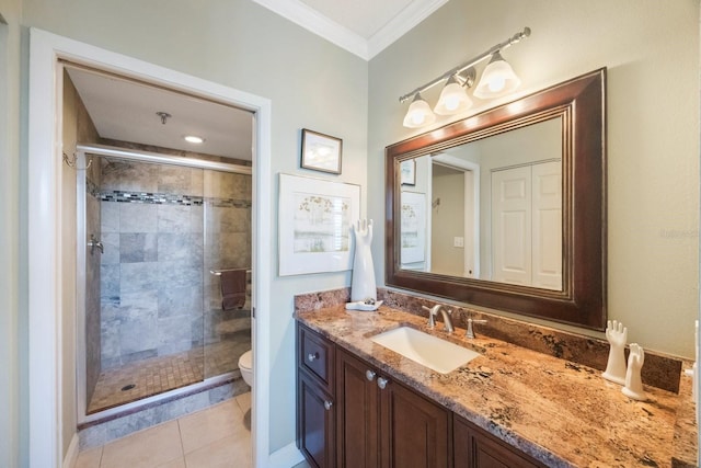 bathroom with crown molding, toilet, a shower stall, vanity, and tile patterned floors