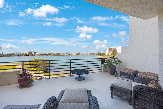 view of patio featuring a water view and a balcony