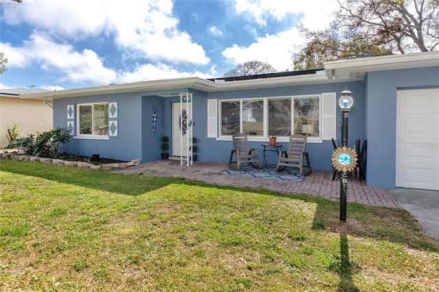 view of front of property with a garage and a front yard