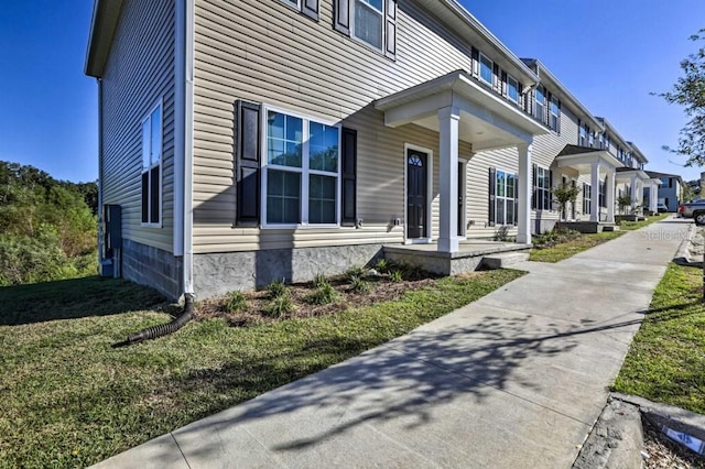 view of side of home with a yard