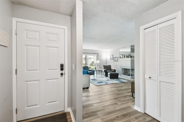 foyer featuring hardwood / wood-style floors and a textured ceiling