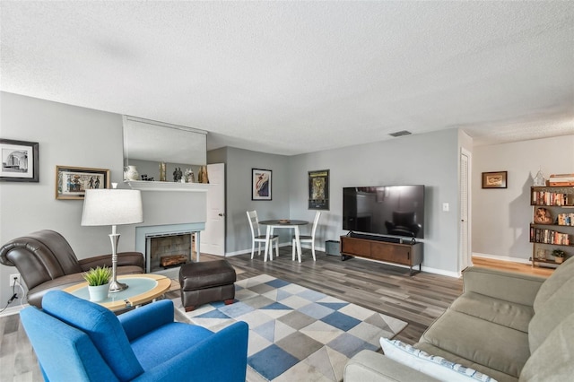 living room featuring a textured ceiling and dark hardwood / wood-style flooring