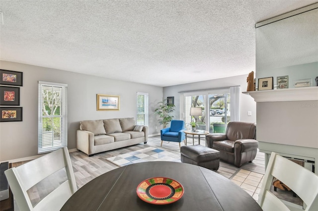 living room featuring a textured ceiling and light tile patterned flooring