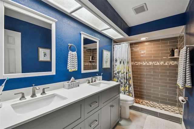 bathroom featuring vanity, toilet, and a shower with shower curtain