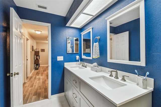 bathroom featuring hardwood / wood-style flooring and vanity