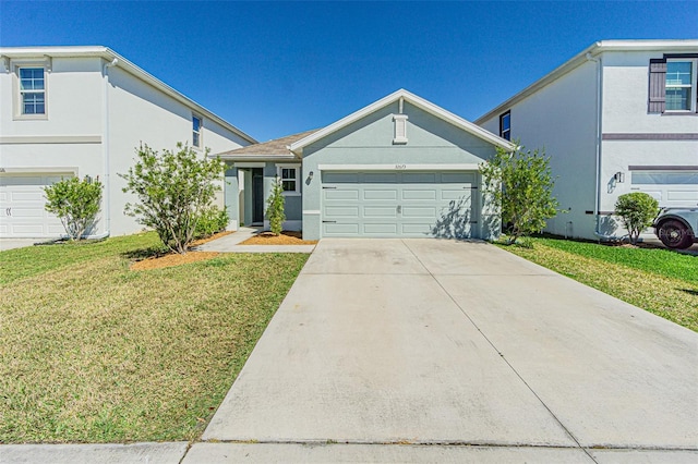 view of front facade featuring a front lawn and a garage