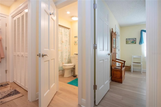 hallway featuring light wood-style flooring
