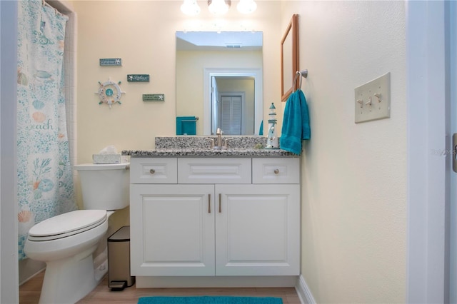bathroom featuring curtained shower, vanity, toilet, and visible vents
