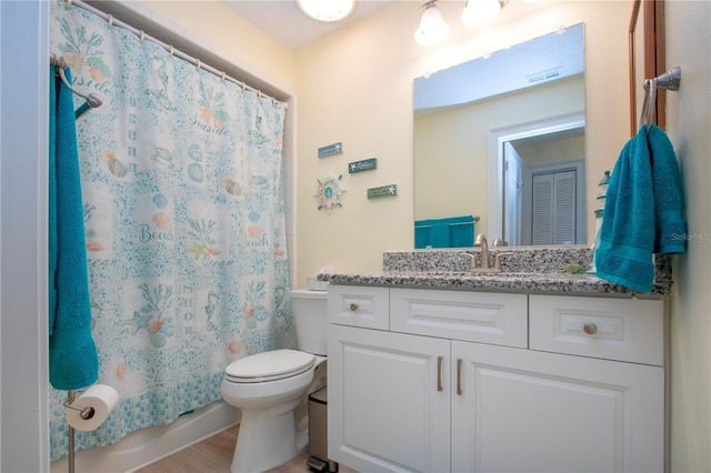 bathroom with vanity, toilet, visible vents, and wood finished floors