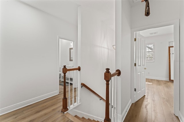 corridor with light hardwood / wood-style floors