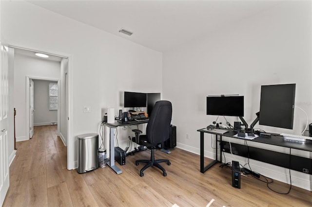 office space with light wood-type flooring