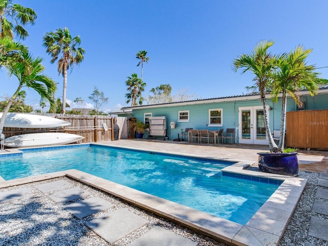 view of swimming pool featuring a patio area and french doors