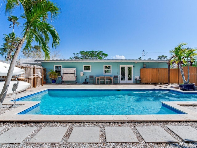 view of pool featuring french doors