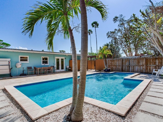 view of pool with a patio area and french doors