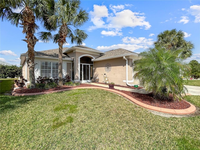 ranch-style house with a front yard and stucco siding