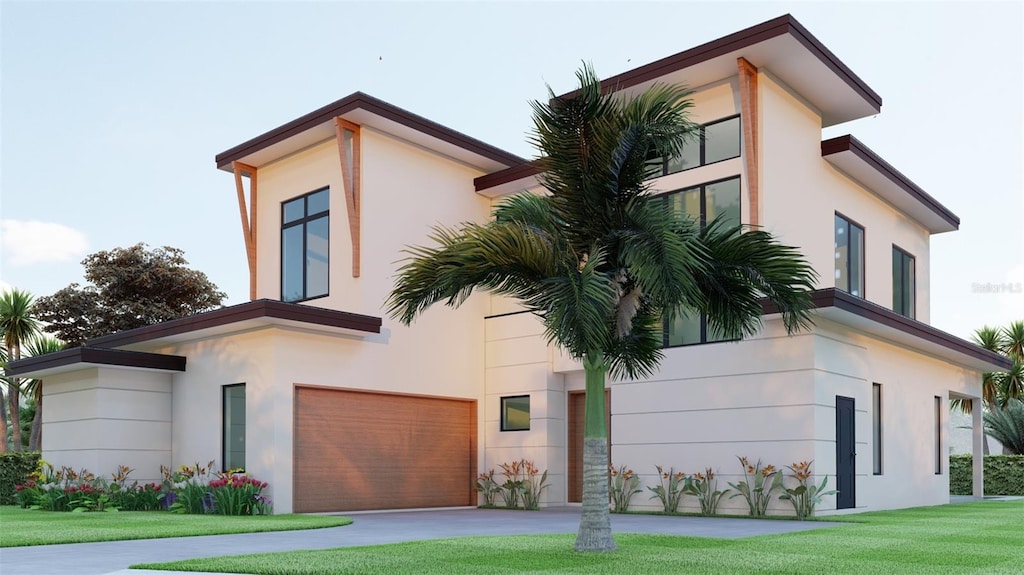 view of front of home featuring a garage and a front lawn