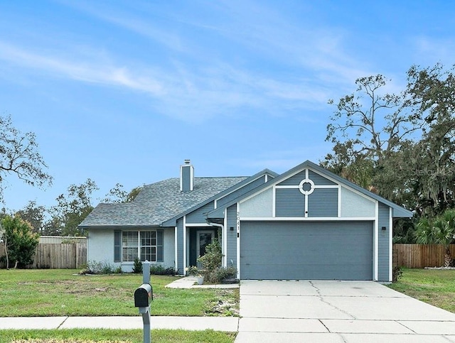 single story home featuring a garage and a front yard