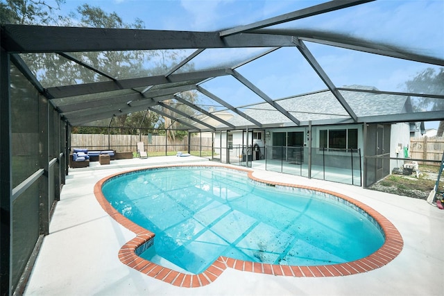 view of pool with a patio and glass enclosure