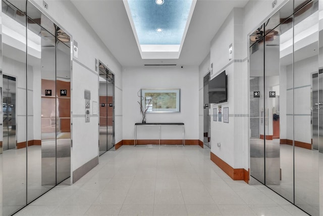 777 N Ashley Dr Unit 1915, Tampa, FL 33602 - hallway featuring elevator, light tile patterned floors, and a skylight