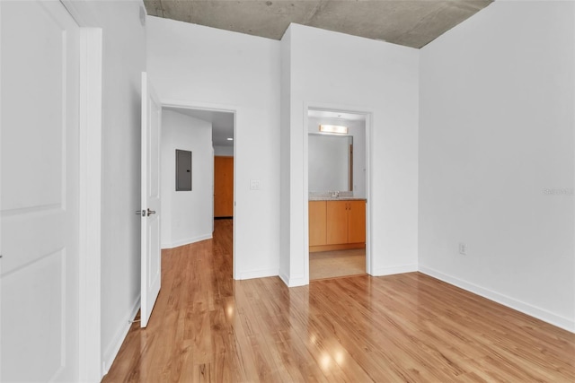 777 N Ashley Dr Unit 1915, Tampa, FL 33602 - unfurnished bedroom featuring sink, electric panel, ensuite bathroom, and light wood-type flooring