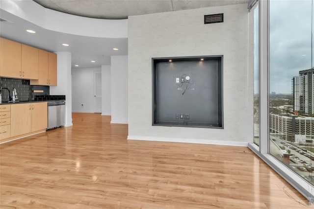 777 N Ashley Dr Unit 1915, Tampa, FL 33602 - kitchen with a wealth of natural light, light brown cabinetry, dishwasher, decorative backsplash, and light hardwood / wood-style floors