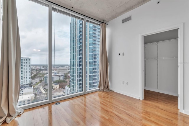 777 N Ashley Dr Unit 1915, Tampa, FL 33602 - spare room with expansive windows and hardwood / wood-style flooring