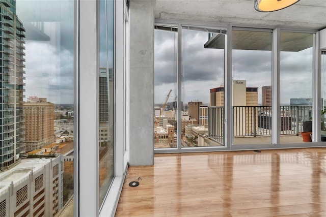 777 N Ashley Dr Unit 1915, Tampa, FL 33602 - unfurnished room with floor to ceiling windows and light hardwood / wood-style floors