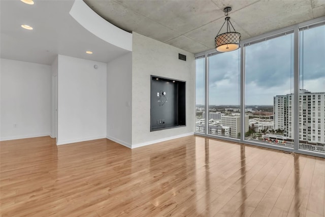 777 N Ashley Dr Unit 1915, Tampa, FL 33602 - empty room featuring expansive windows and light wood-type flooring