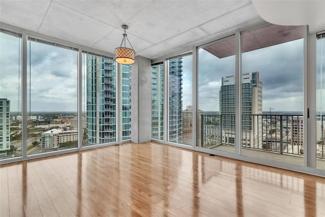 777 N Ashley Dr Unit 1915, Tampa, FL 33602 - empty room with expansive windows and hardwood / wood-style floors