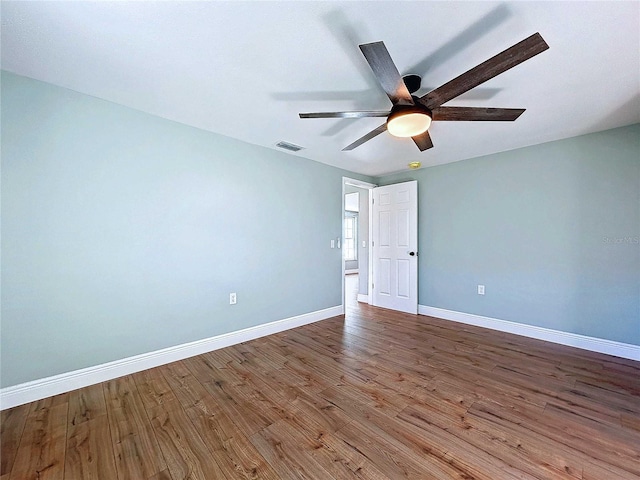 spare room with hardwood / wood-style flooring and ceiling fan