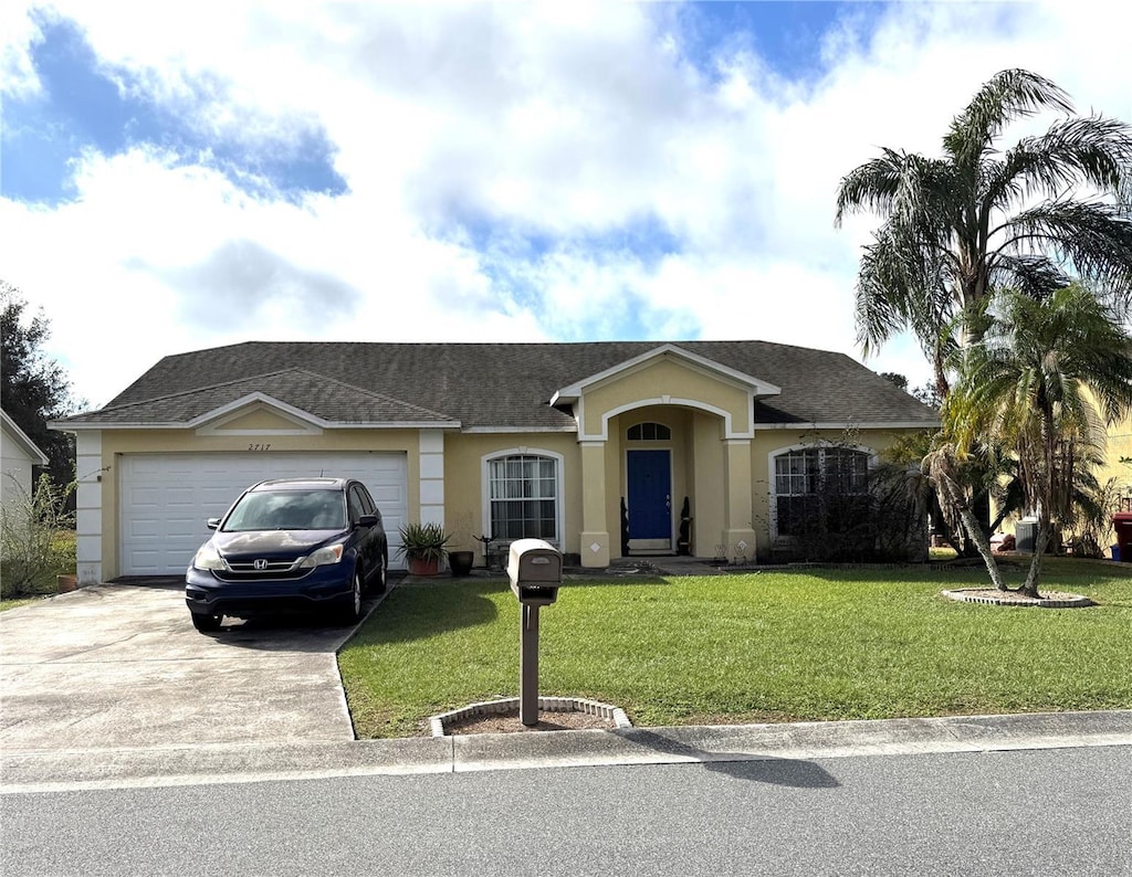 ranch-style house with a front lawn and a garage