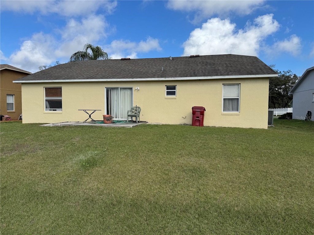 back of house featuring a patio and a lawn