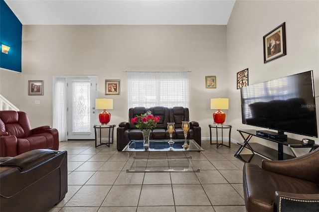 tiled living room featuring a high ceiling