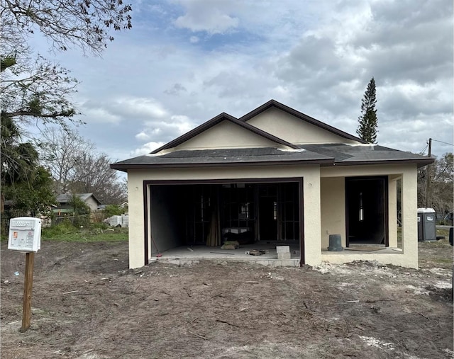 view of front of house featuring a garage and stucco siding