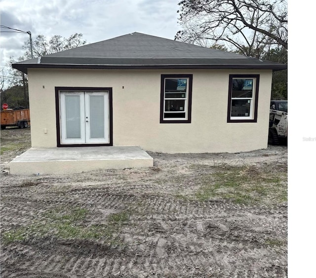 back of property with a patio, french doors, and stucco siding