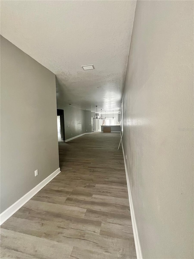 3413 N 72nd St, Tampa, FL 33619 - hallway with baseboards, wood finished floors, and a textured ceiling