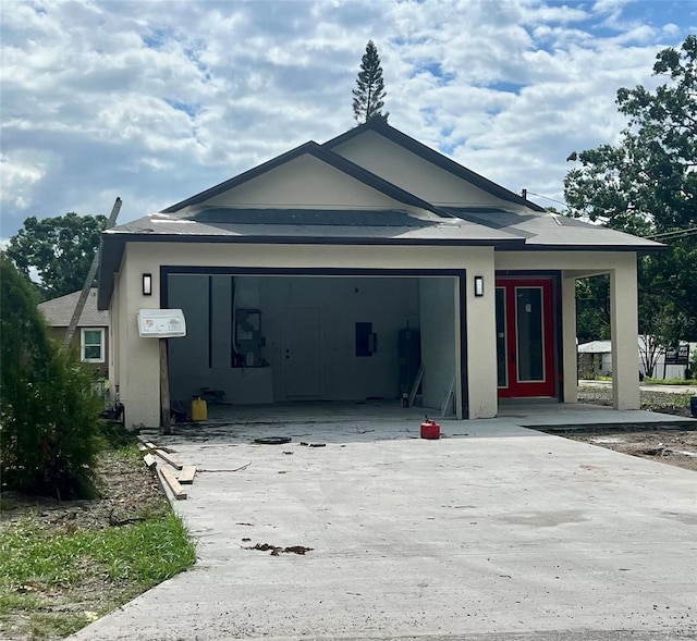 3413 N 72nd St, Tampa, FL 33619 - view of front of home featuring driveway, an attached garage, and stucco siding