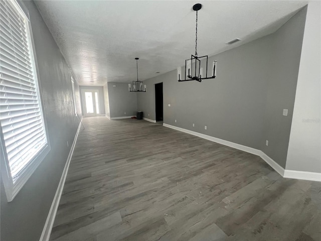 3413 N 72nd St, Tampa, FL 33619 - unfurnished dining area with a chandelier, wood finished floors, and baseboards
