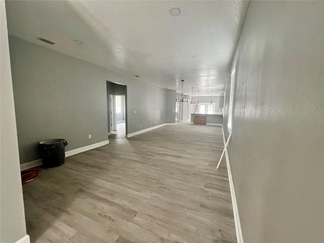 3413 N 72nd St, Tampa, FL 33619 - unfurnished living room featuring wood finished floors and baseboards